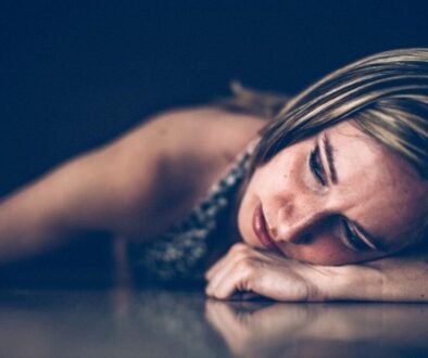 Woman lying down in quiet emotional pain during a season of depression